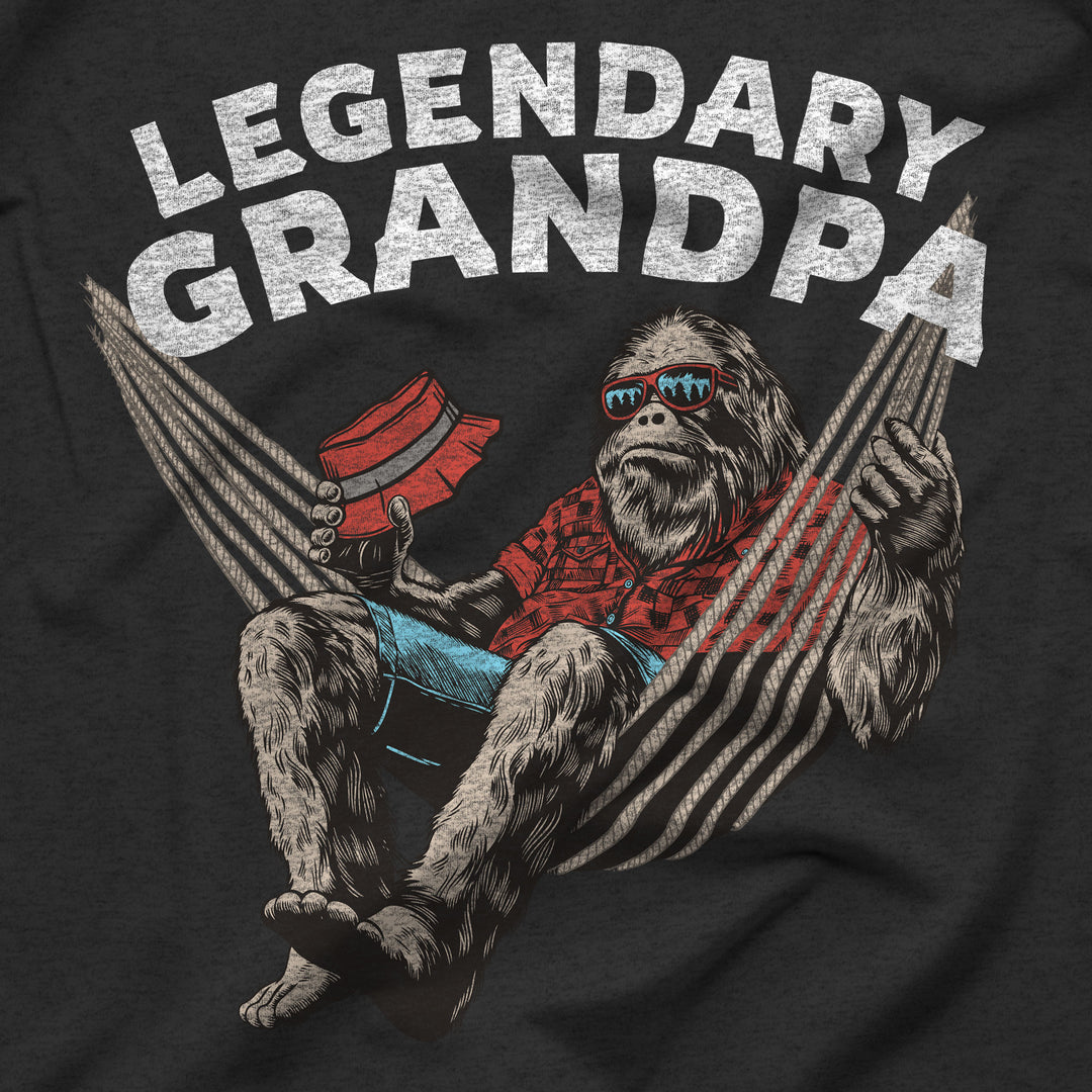 T-shirt with a graphic of a bigfoot sasquatch in sunglasses and a hat, sitting in a hammock with &